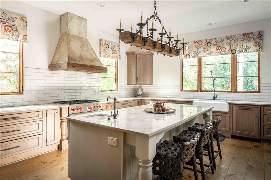 3118 West Roxboro Road Northeast Atlanta, GA 30324 - Photo 25 of 68 a kitchen with a sink a stove a dining table and chairs