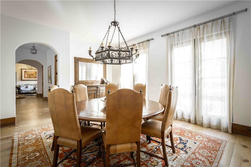 3118 West Roxboro Road Northeast Atlanta, GA 30324 - Photo 32 of 68 a dining room with furniture a chandelier and wooden floor