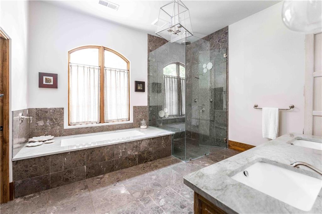 3118 West Roxboro Road Northeast Atlanta, GA 30324 - Photo 43 of 68 a spacious bathroom with a granite countertop tub sink and mirror