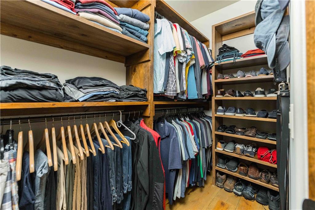 3118 West Roxboro Road Northeast Atlanta, GA 30324 - Photo 47 of 68 a view of walk in closet with clothes and shoes