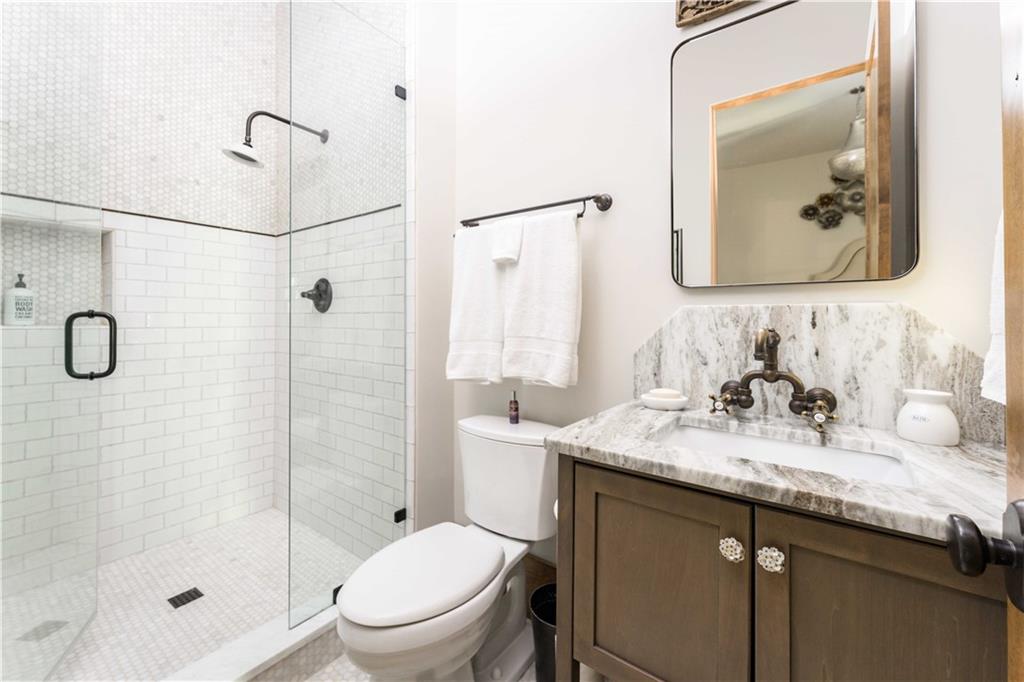 3118 West Roxboro Road Northeast Atlanta, GA 30324 - Photo 50 of 68 a bathroom with a granite countertop sink toilet and shower