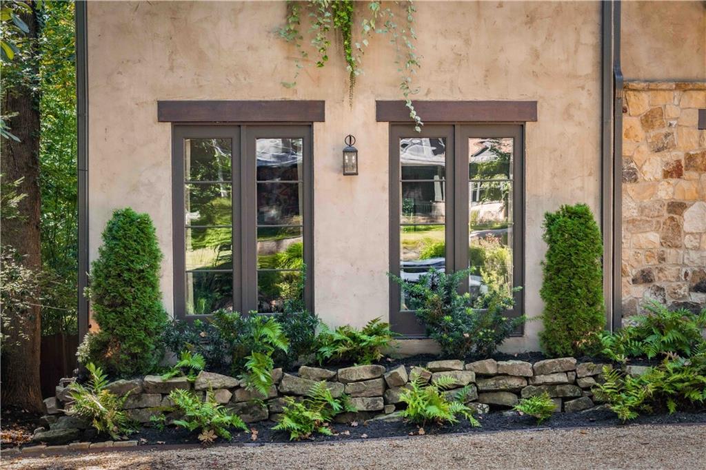 3118 West Roxboro Road Northeast Atlanta, GA 30324 - Photo 8 of 68 a front view of a house with a yard and potted plants