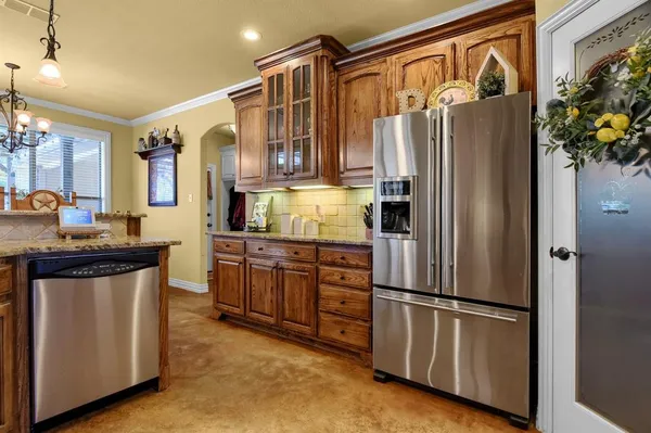 a kitchen with stainless steel appliances granite countertop a refrigerator and a refrigerator