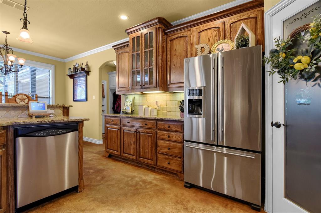 710 Highway 82 Bells, TX 75414 - Photo 12 of 40 a kitchen with stainless steel appliances granite countertop a refrigerator and a refrigerator