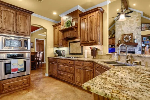 a kitchen with stainless steel appliances granite countertop a sink and cabinets