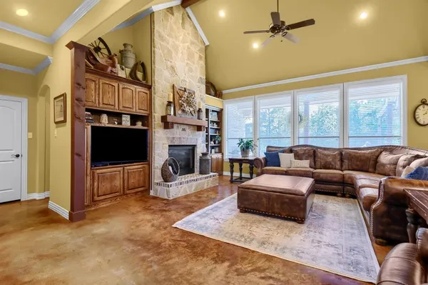 a living room with fireplace furniture and a flat screen tv
