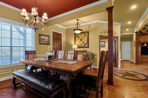 a view of a dining room with furniture and a chandelier