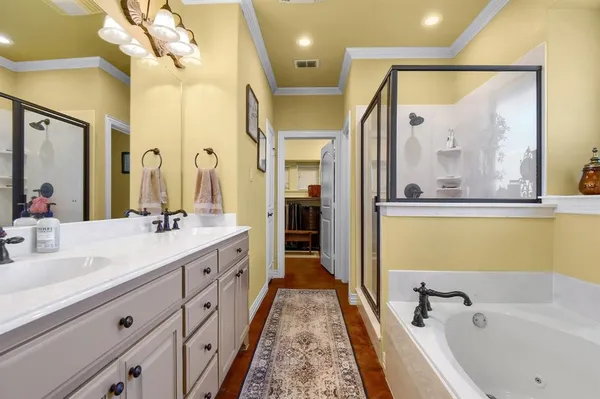 a spacious bathroom with a tub sink and mirror