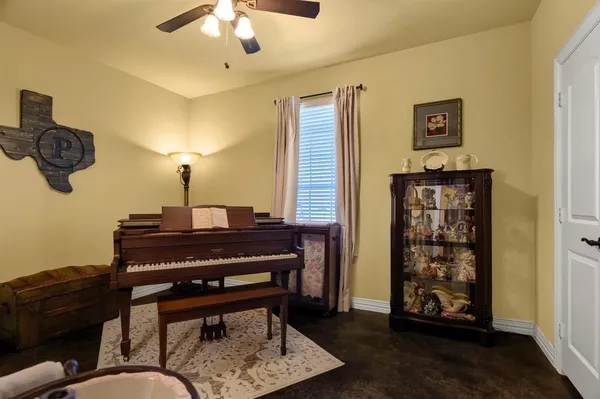 a living room with furniture and a piano