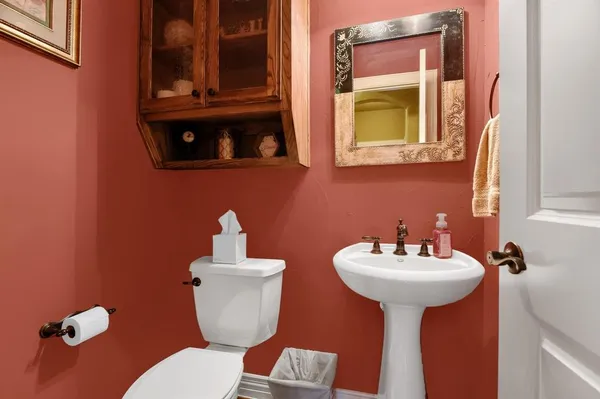 a bathroom with a sink mirror and toilet