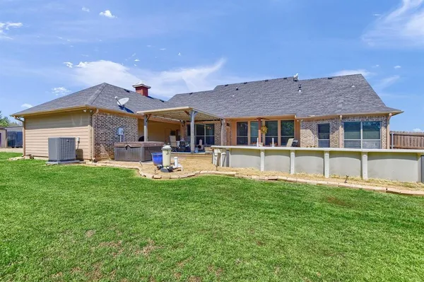 a view of a house with a yard and sitting area