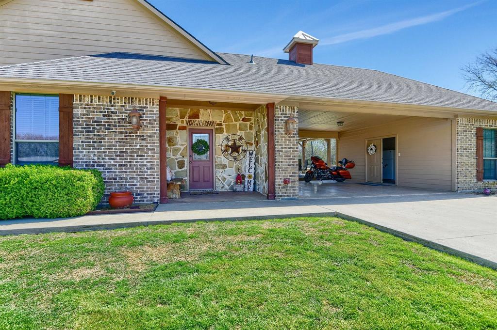 710 Highway 82 Bells, TX 75414 - Photo 30 of 40 a view of a porch with a table and chairs under an umbrella