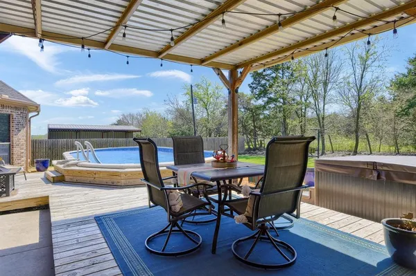 a view of a dinning table and chairs in patio