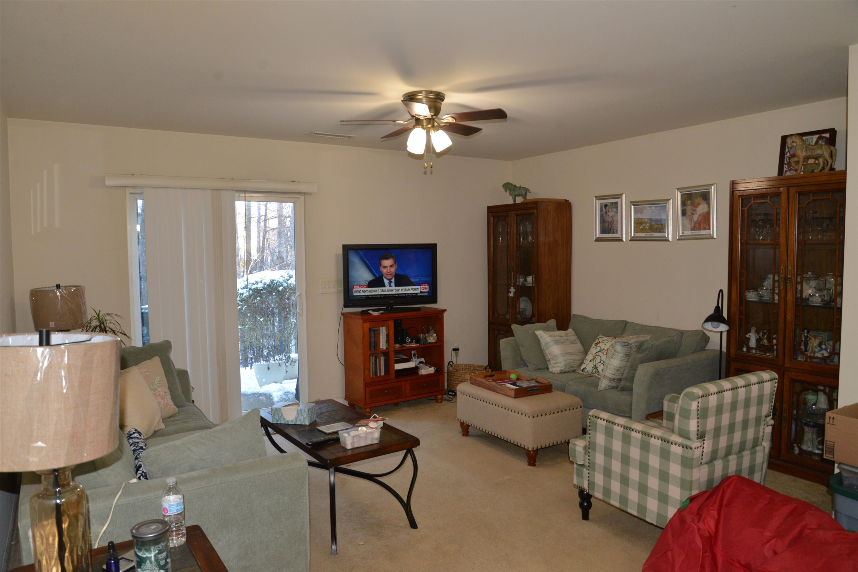 8533 Quarton Drive Raleigh, NC 27616 - Photo 4 of 20 a living room with furniture and a flat screen tv with wooden floor