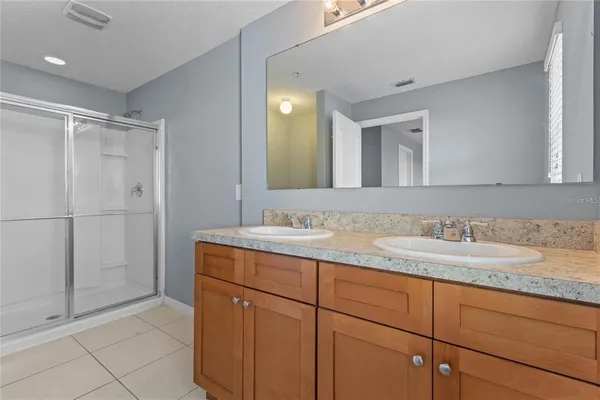 a bathroom with a granite countertop sink mirror and double