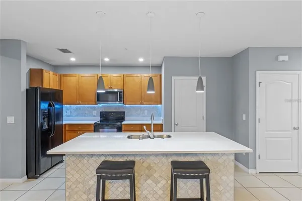 a kitchen with stainless steel appliances a sink and a refrigerator