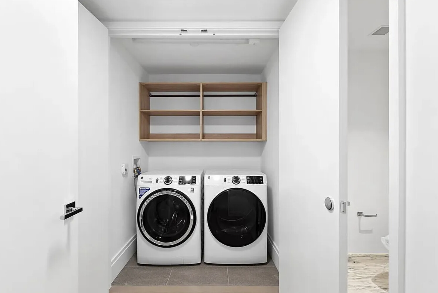 50 West 66th Street, Unit 9B Manhattan, NY 10023 - Photo 3 of 21 a utility room with dryer and washer