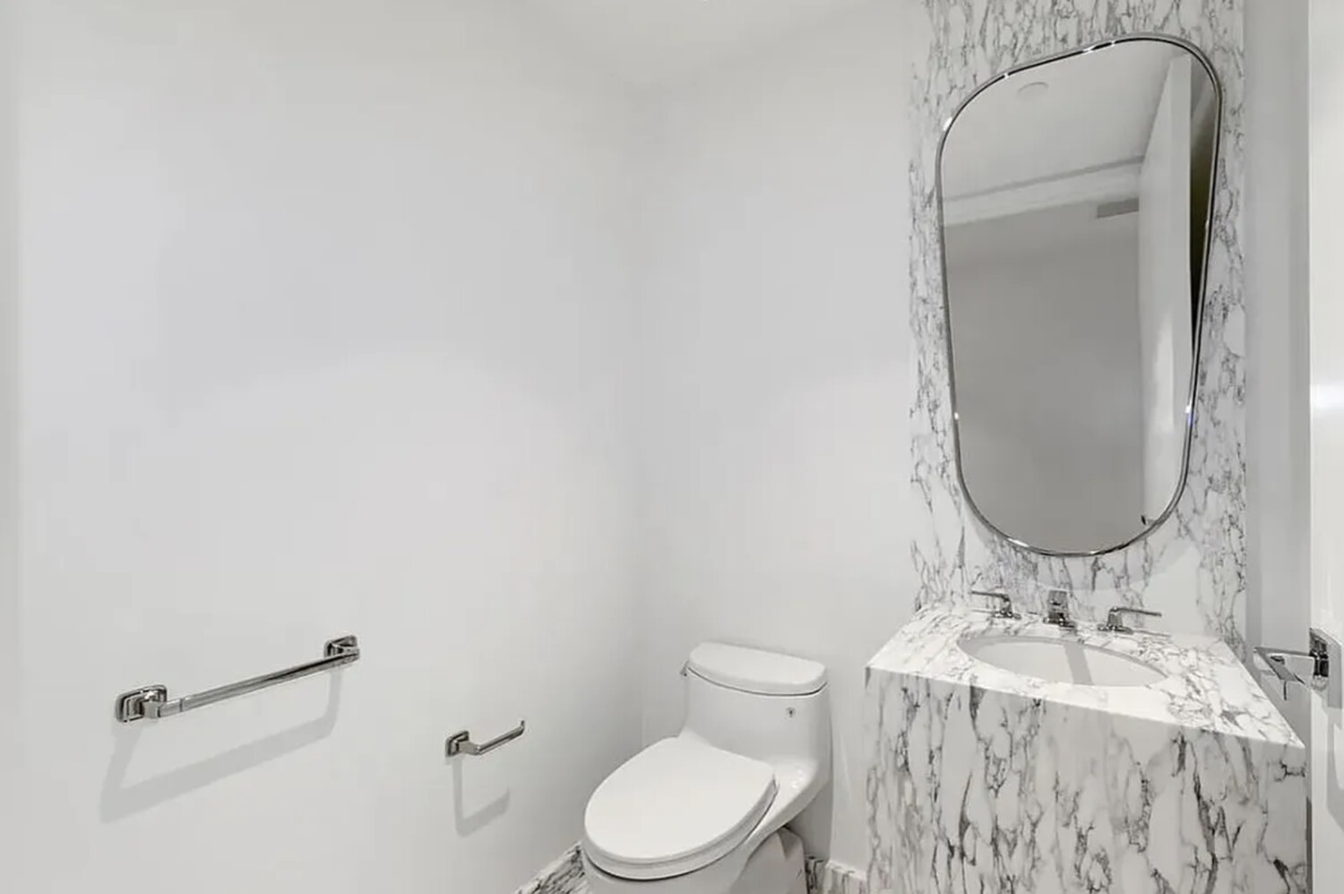 50 West 66th Street, Unit 9B Manhattan, NY 10023 - Photo 4 of 21 a bathroom with a granite countertop sink mirror vanity and toilet