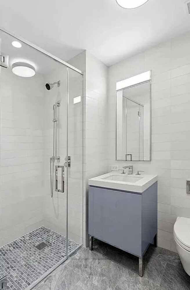 50 West 66th Street, Unit 9B Manhattan, NY 10023 - Photo 9 of 21 a bathroom with a sink a toilet and shower