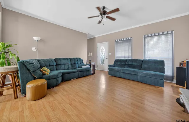 a living room with furniture a couch and a potted plant