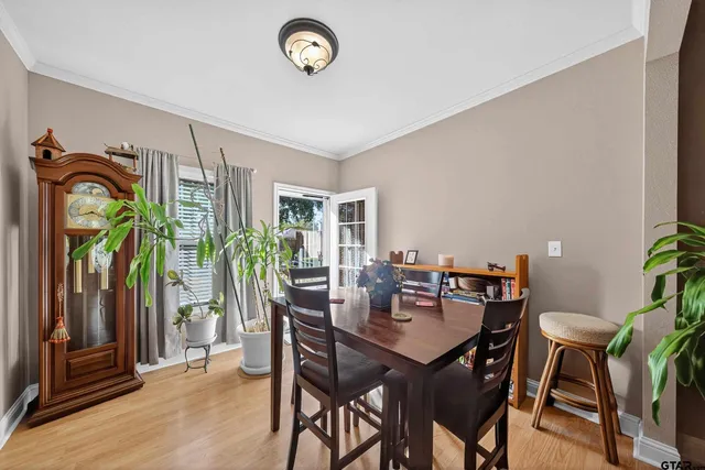 a view of a dining room with furniture and chandelier