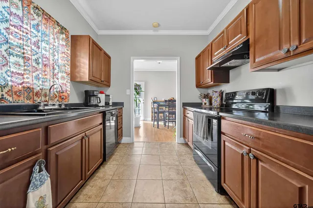 a kitchen with stainless steel appliances granite countertop a sink and cabinets
