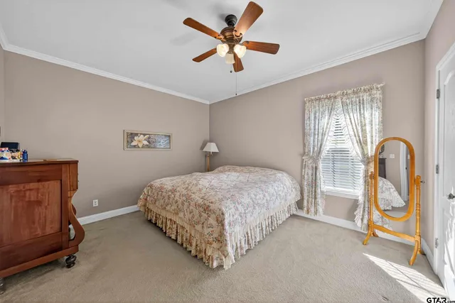 a spacious bedroom with a bed and a chandelier
