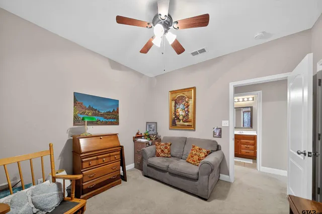 a living room with furniture and a baby crib