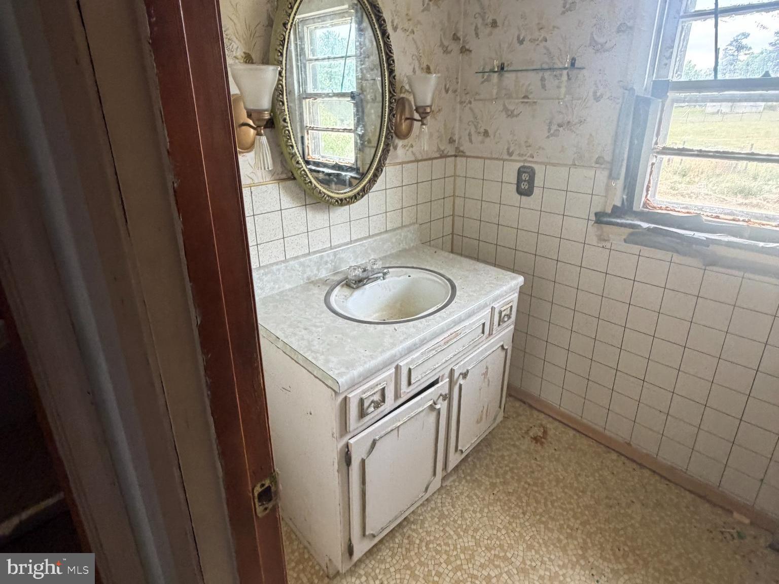 7114 Marye Road Spotsylvania, VA 22551 - Photo 9 of 11 a bathroom with a sink and a mirror