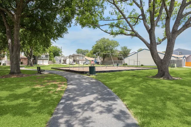 a view of a yard with large trees