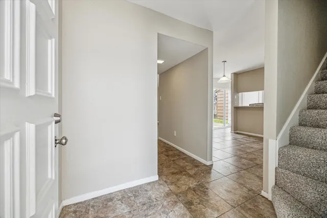 a view of a kitchen with a refrigerator cabinets and a wooden floor