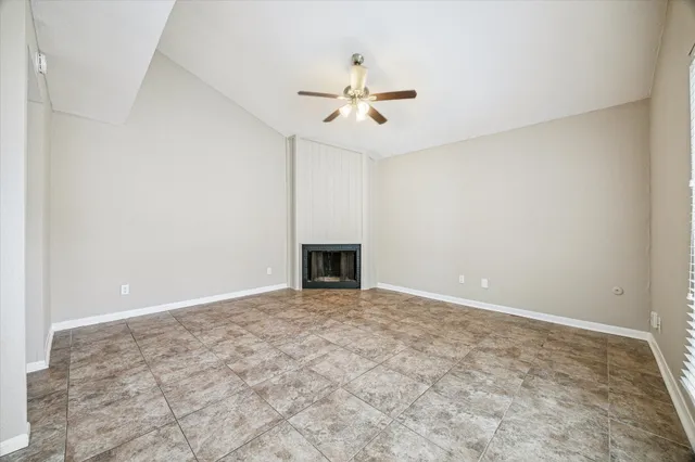 a view of a hallway with wooden floor and a living room