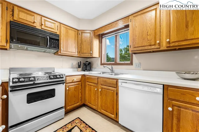 a spacious bathroom with a granite countertop sink a toilet a mirror and shower
