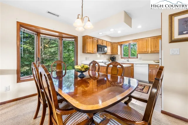 a kitchen with stainless steel appliances granite countertop a sink a stove and a refrigerator