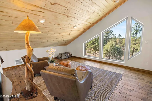 a balcony with couch and wooden floor