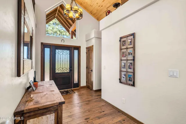 a hallway with a large window and wooden floor