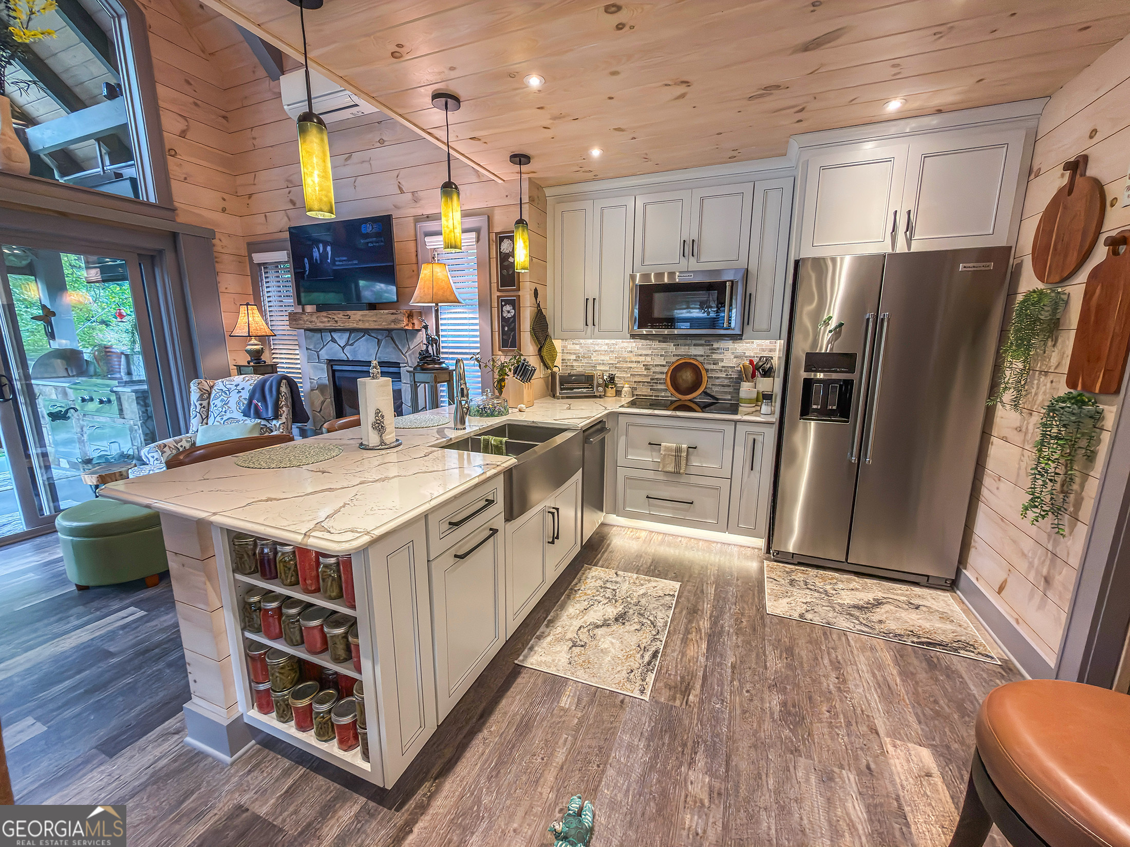 111 Wildflower Road Scaly Mountain, NC 28775 - Photo 23 of 52 a kitchen with stainless steel appliances a stove a sink dishwasher a refrigerator and a microwave oven with wooden floor