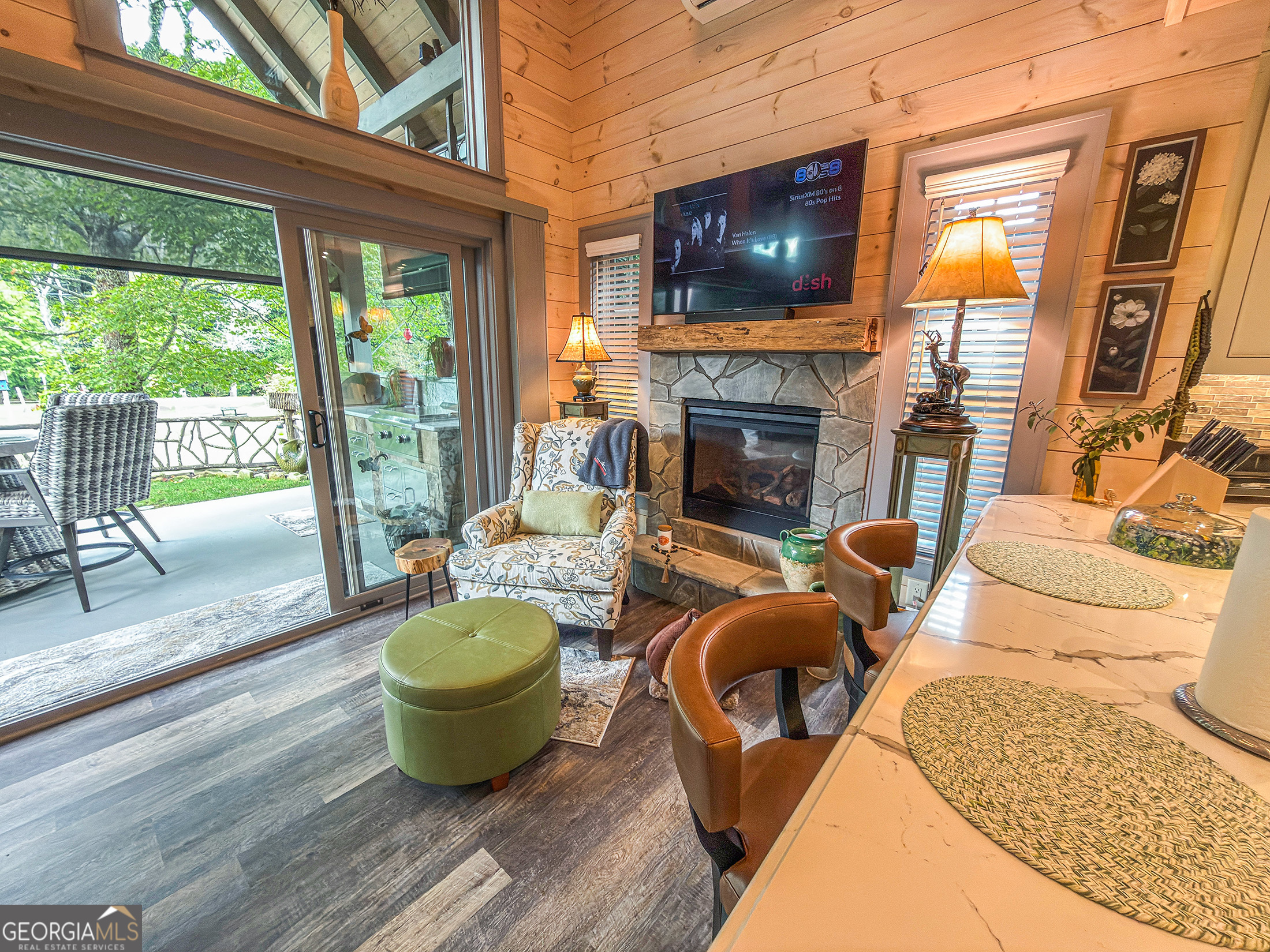 111 Wildflower Road Scaly Mountain, NC 28775 - Photo 24 of 52 a living room with furniture a fireplace and a flat screen tv