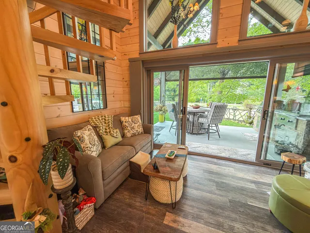 a living room with furniture and a floor to ceiling window