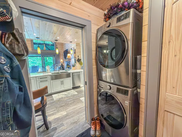 a kitchen with stainless steel appliances kitchen island granite countertop a stove and a sink