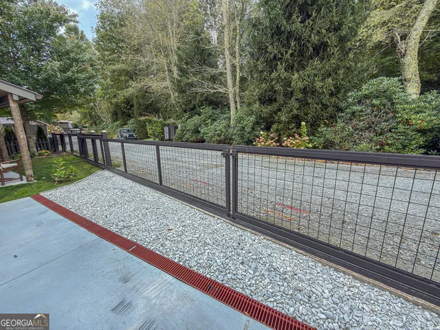 a front view of a house with a garden and parking space