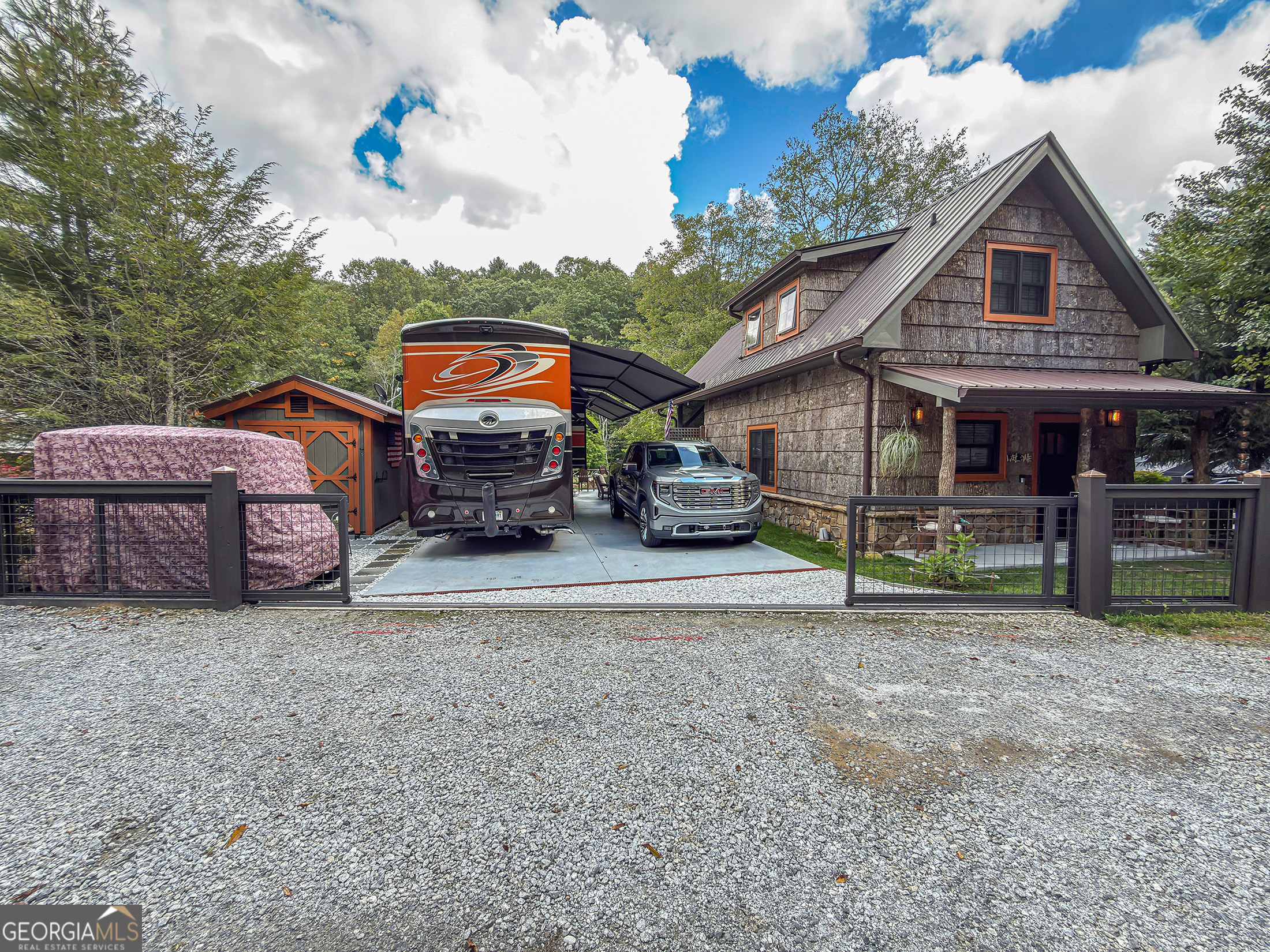111 Wildflower Road Scaly Mountain, NC 28775 - Photo 46 of 52 a front view of a house with a garden and parking space