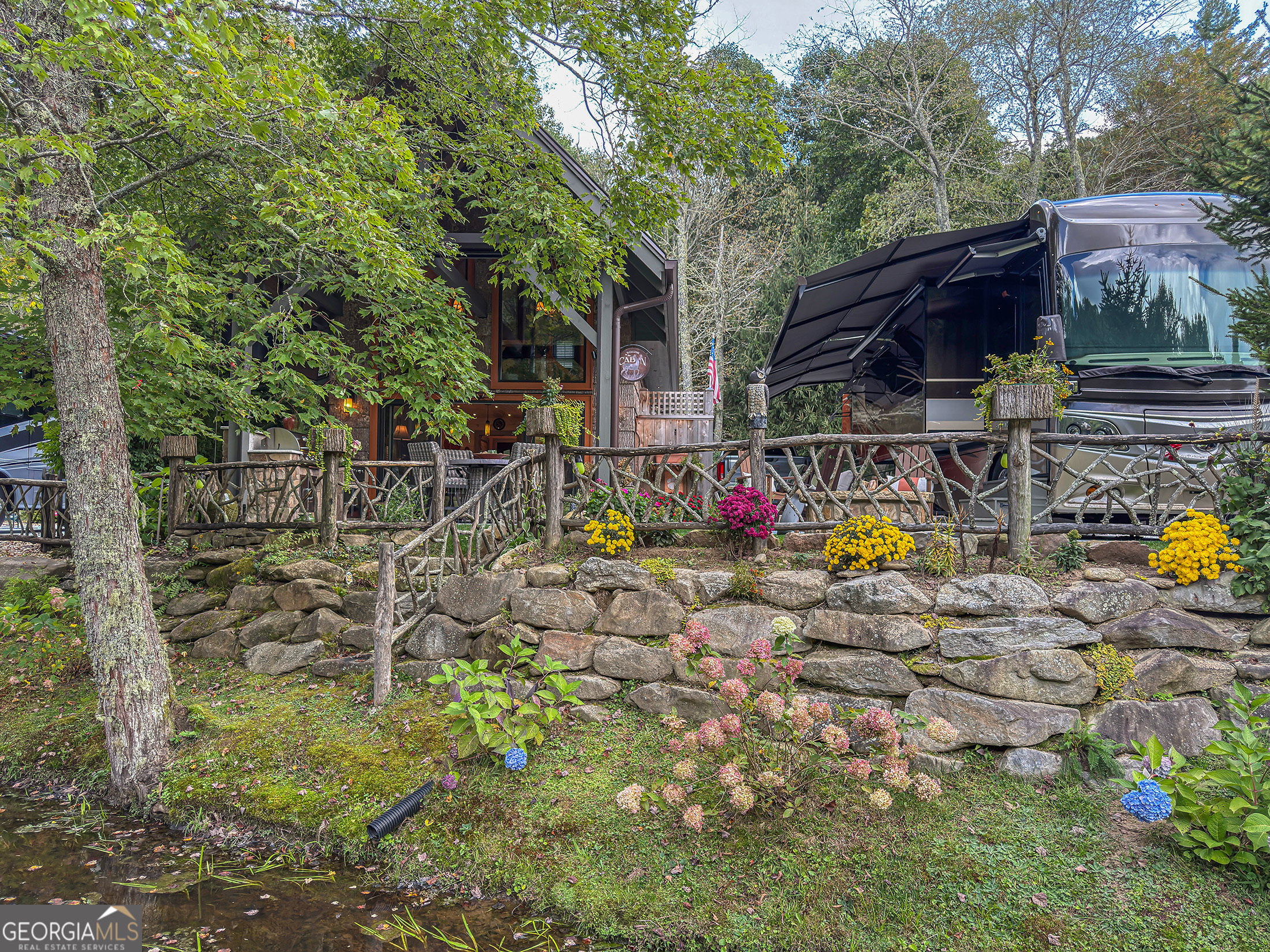 111 Wildflower Road Scaly Mountain, NC 28775 - Photo 49 of 52 a front view of a house with garden
