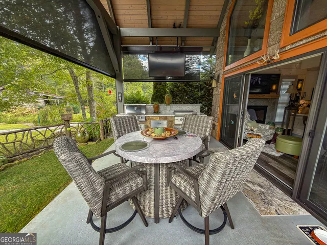 a view of a patio with couches table and chairs and potted plants