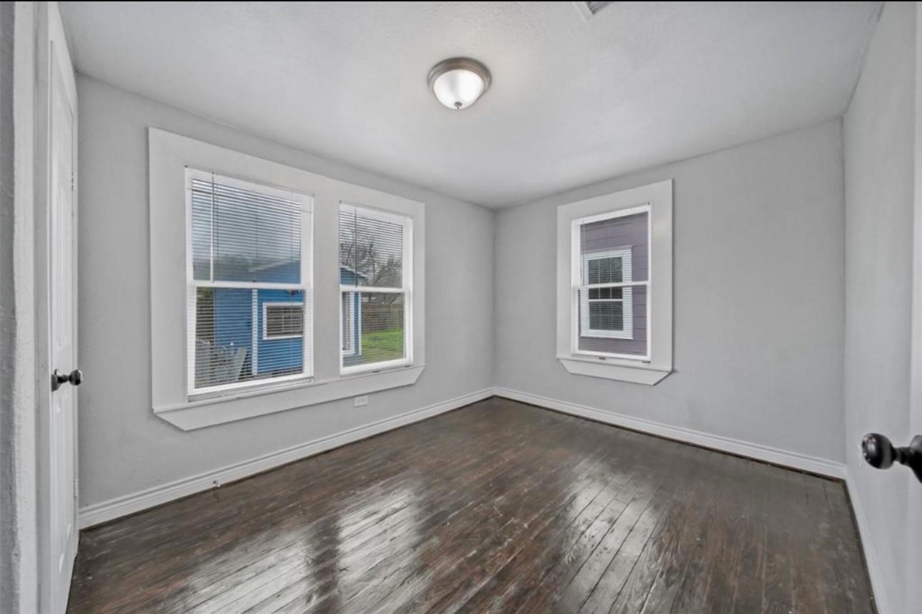 2205 Sumpter Street Houston, TX 77026 - Photo 3 of 7 a view of an empty room with a window and wooden floor