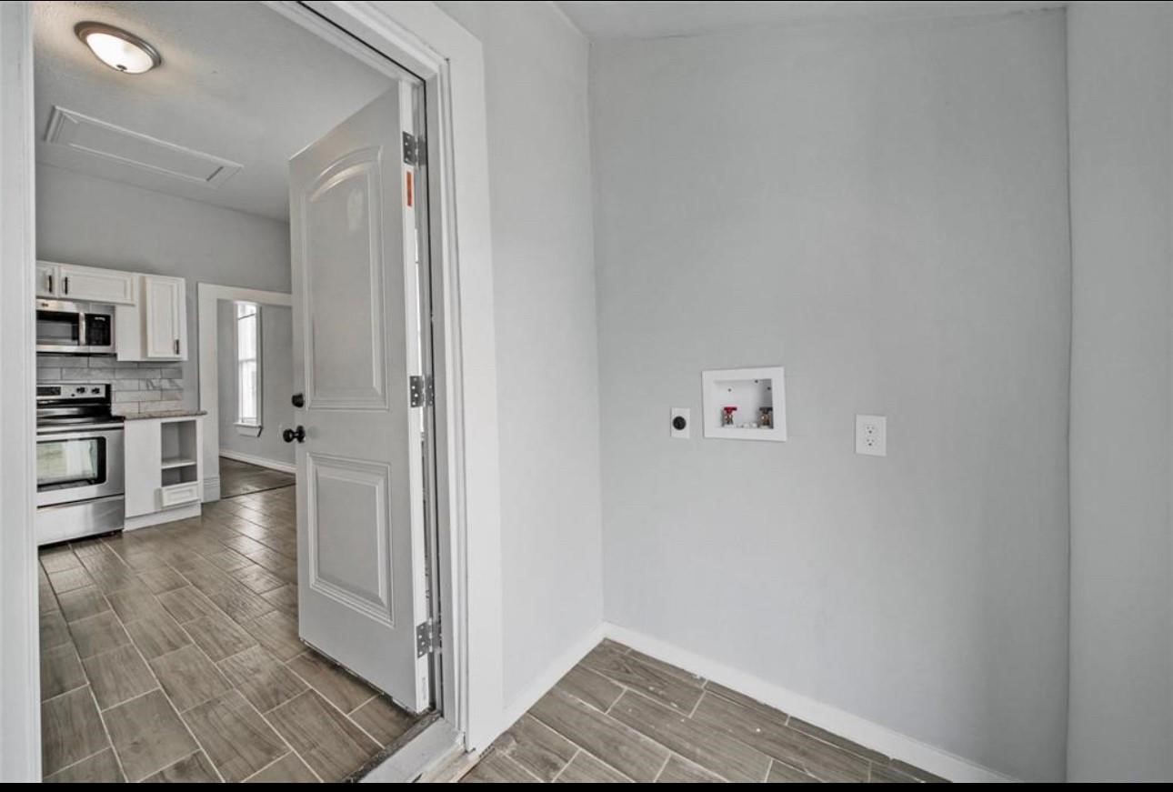 2205 Sumpter Street Houston, TX 77026 - Photo 6 of 7 a view of a kitchen with wooden floor