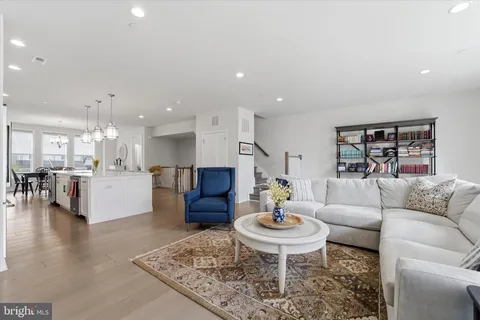 a living room with furniture and kitchen view