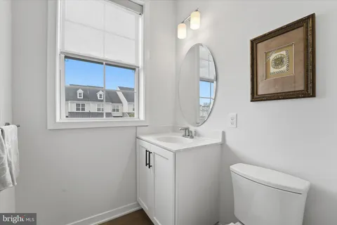 a bathroom with a toilet a sink and mirror