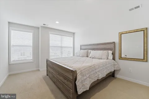 a bed sitting in a bedroom next to a window