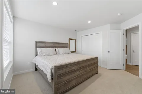 a bed room with a bed and a night stand